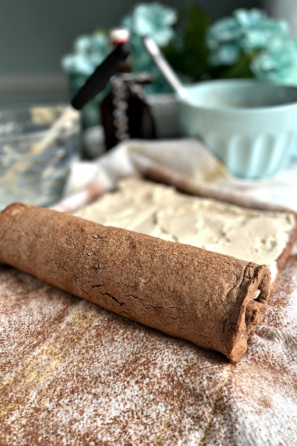 Rolling the mocha yule log after adding the cream filling.