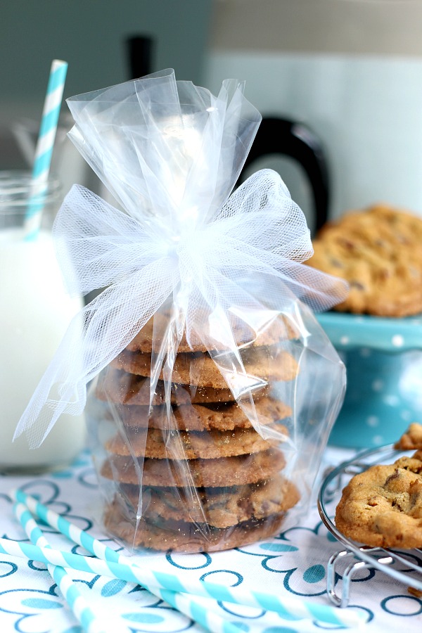 Appreciated Christmas holiday food gifts from you kitchen include packaged chocolate chip cookies with a festive bow.
