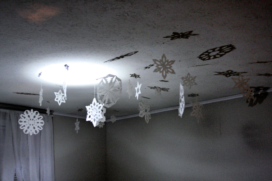 Winter decorating by hanging paper snowflakes to delight kids.