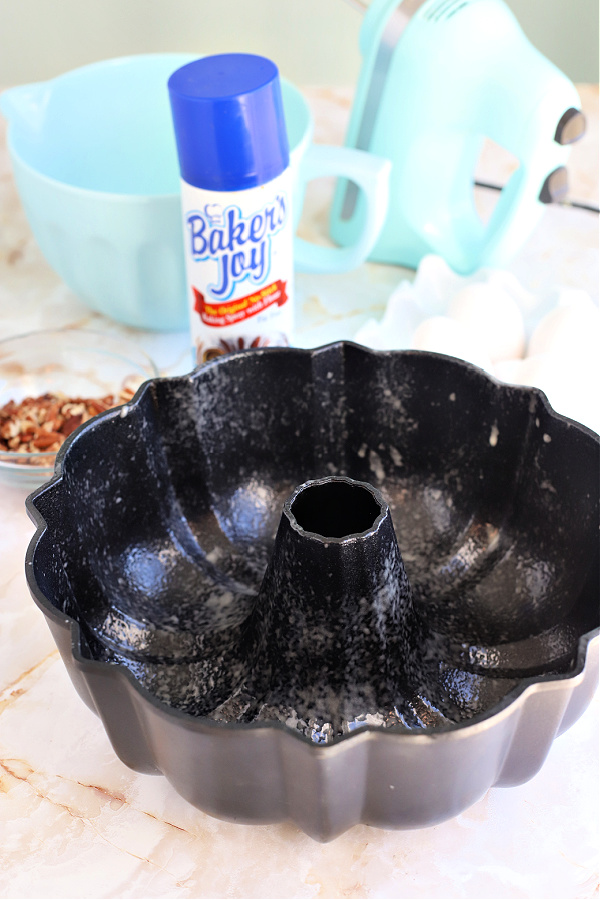 Spraying a Bundt pan with PAM to grease. before pouring in the batter.