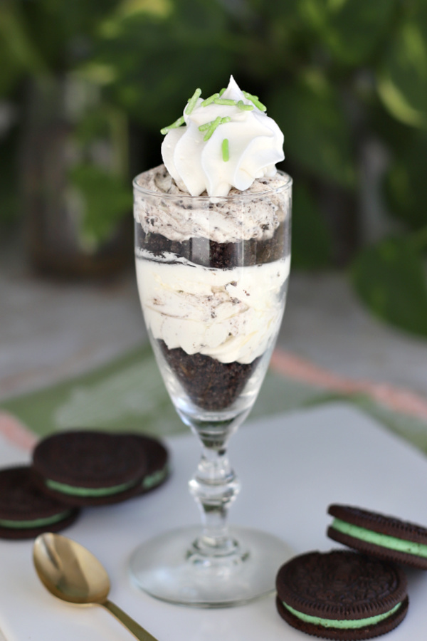 Easy no bake recipe for chocolate mint cheesecake parfait with Oreo crumbs, peppermint and cream cheese. Perfect St Patrick's Day dessert.