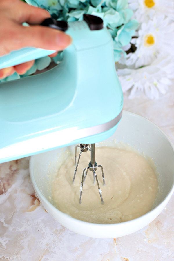 Using a mixer for combining the 3 ingredients for making Goop easy cake pan release for baking.