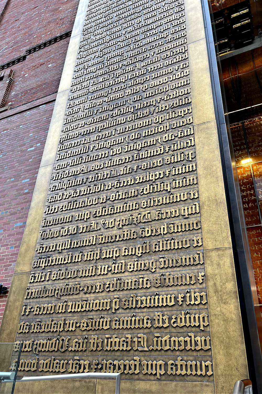 Museum of the Bible 40-foot bronze gates whose panels contain the first 80 lines of Genesis written in Latin originally printed in an early edition of the Gutenberg Bible.