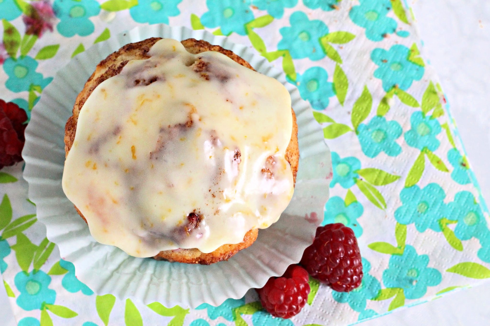 Easy recipe for classic muffin with your favorite berry. These very berry muffins are filled with raspberries with an orange glaze frosting.