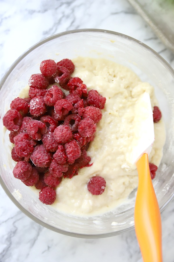 Adding the fresh raspberries to the batter for raspberry very berry muffins recipe.