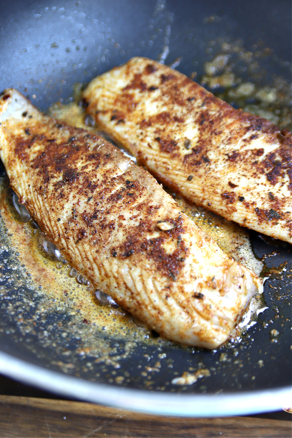 Iron skillet cooking herb and spice rub blackened tilapia.