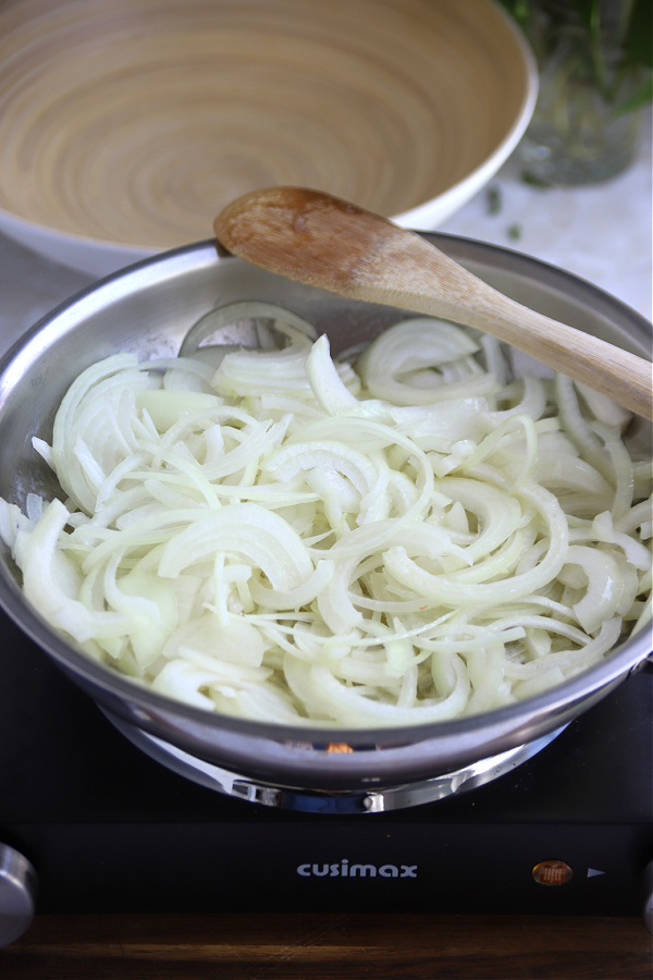 Butter and sliced onions in a skillet.