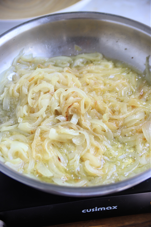 Caramelizing sliced onions and butter for English pub style bangers and mash with onion gravy recipe.