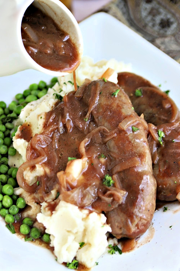 English bangers and mash with onion gravy. Classic browned sausage links and mashed potatoes. 