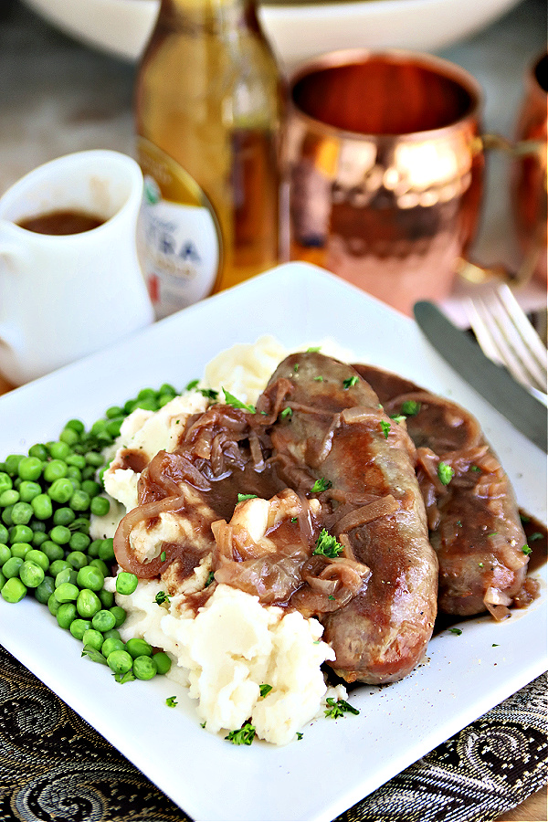 English bangers and mash with onion gravy. Classic browned sausage links and mashed potatoes.