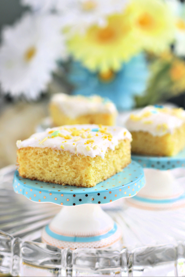 Quick and easy recipe for a moist lemon sheet cake begins with a box mix and lemon curd. Topped with a yummy cream cheese frosting. 