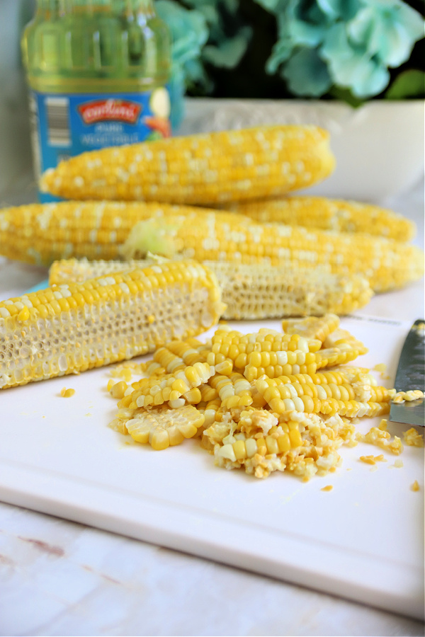cutting fresh corn from the cob for corn fritters