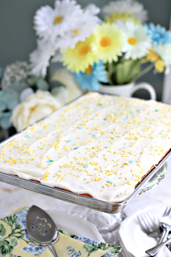 cream cheese frosted lemon sheet cake with sprinkles.