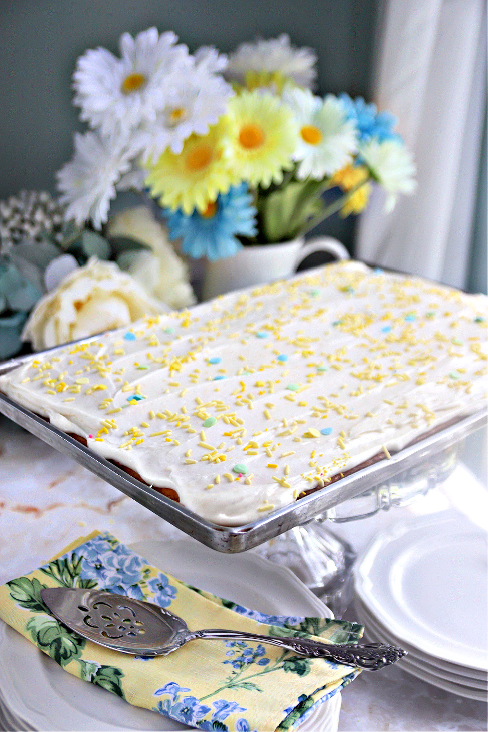 cream cheese frosted lemon sheet cake with sprinkles.
