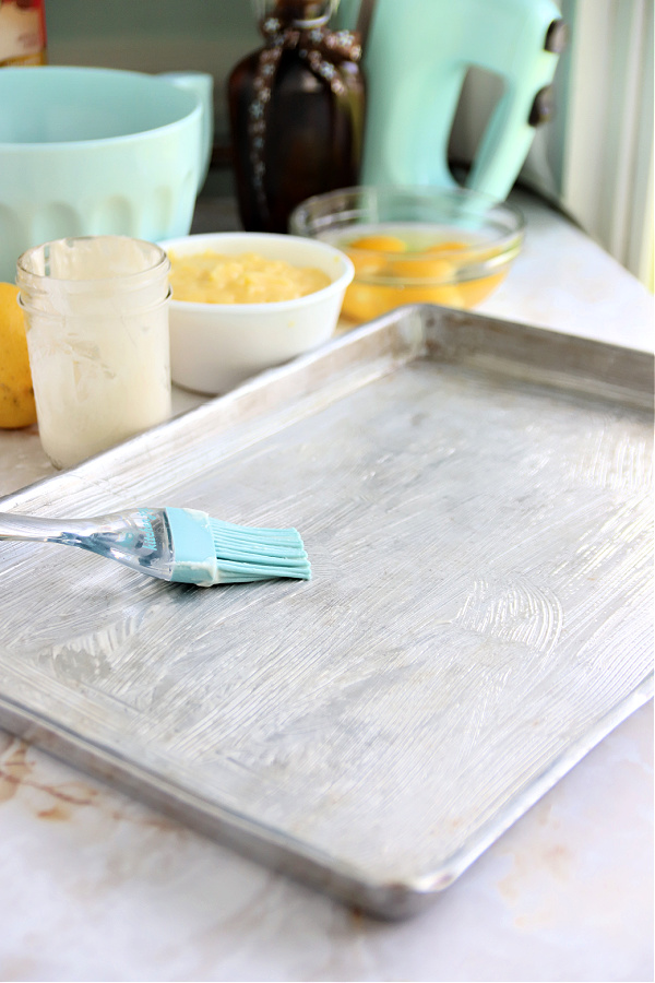 Greasing the pan for lemon sheet cake recipe