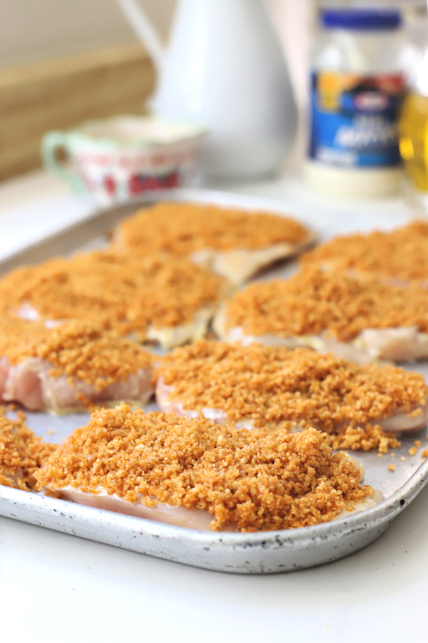 Easy recipe for juicy chicken breasts with a crispy Parmesan and panko coating. Oven baked rather than fried, Parmesan crusted chicken is drizzled with honey mustard sauce. 