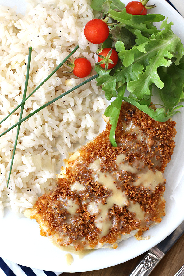 Juicy chicken breasts with a crispy Parmesan and panko coating is oven baked rather than fried. Parmesan crusted chicken drizzled with honey mustard sauce is such an easy recipe!